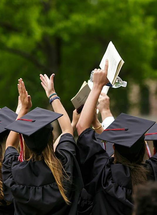 The back view of students wearing black gowns